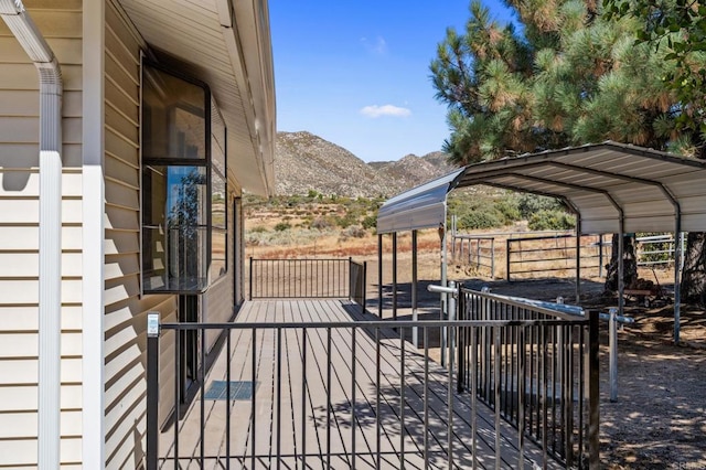 wooden terrace with a mountain view and a carport