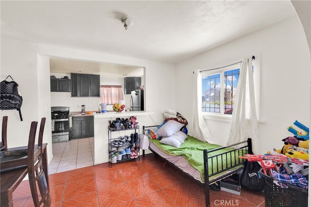 tiled bedroom featuring stainless steel refrigerator