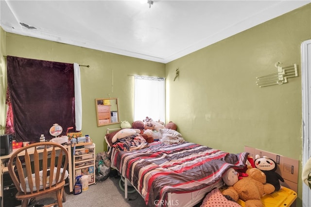 carpeted bedroom with ornamental molding