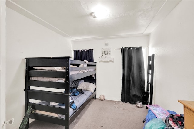 carpeted bedroom with a textured ceiling