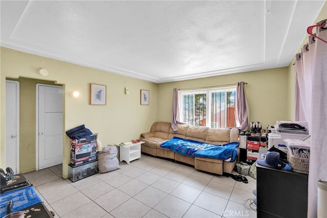 living room with a textured ceiling and light tile patterned flooring