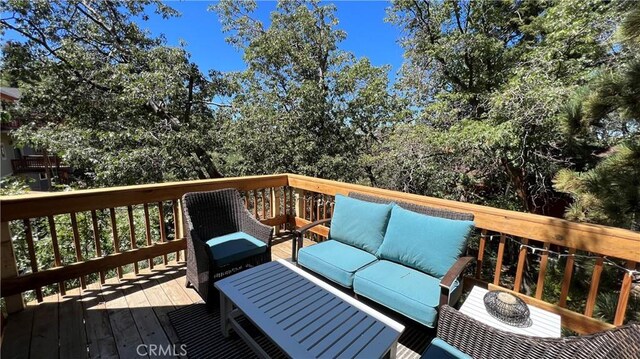 wooden terrace featuring an outdoor living space