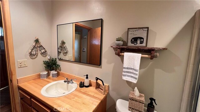 bathroom with toilet and vanity