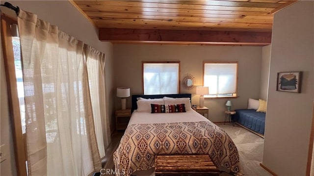 carpeted bedroom featuring beamed ceiling and wood ceiling