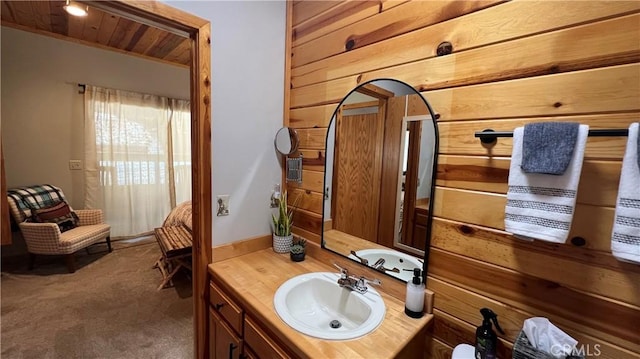 bathroom with vanity, wood ceiling, and wood walls