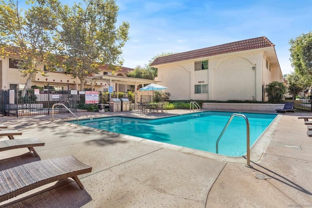 view of swimming pool with a patio area