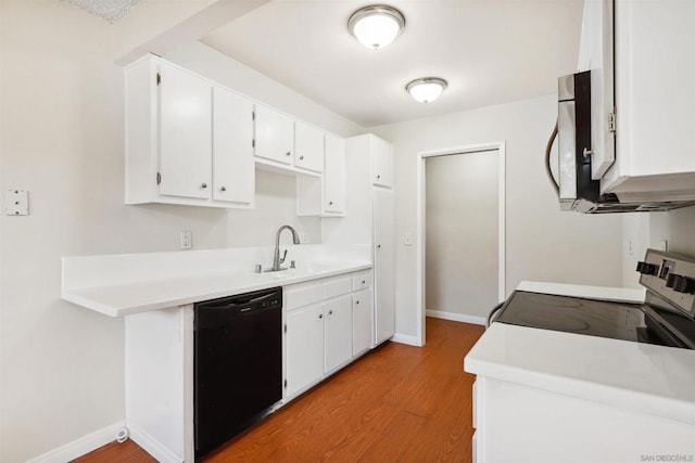 kitchen featuring black dishwasher, sink, white cabinetry, light hardwood / wood-style floors, and stove