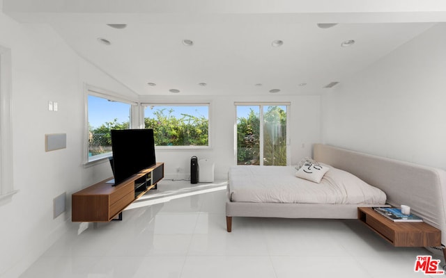 tiled bedroom featuring multiple windows