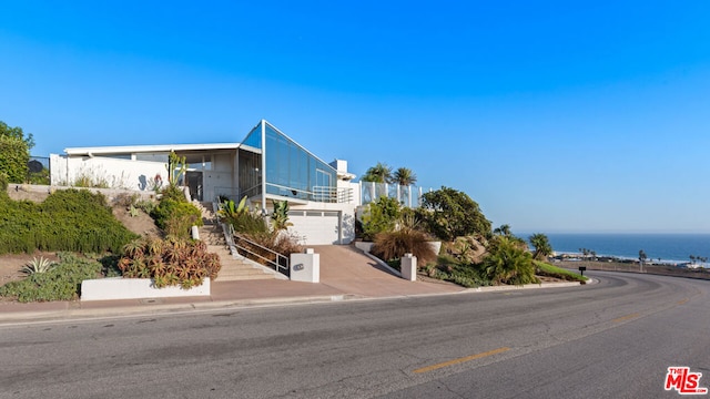 view of front of house with a water view and a garage