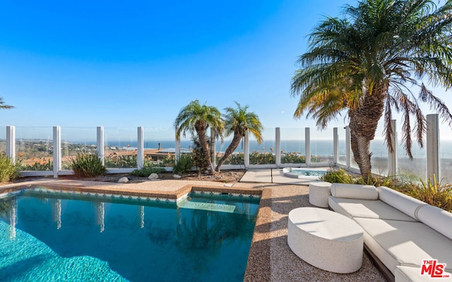 view of pool with a water view