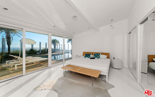 bedroom featuring light tile patterned flooring, access to exterior, and a closet