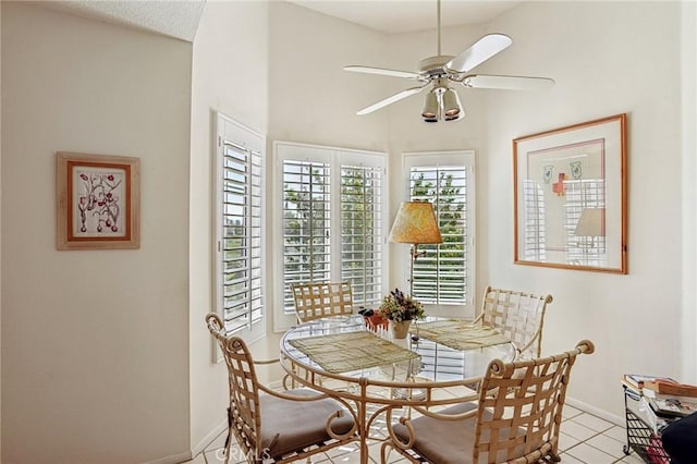 dining space with ceiling fan and light tile patterned floors