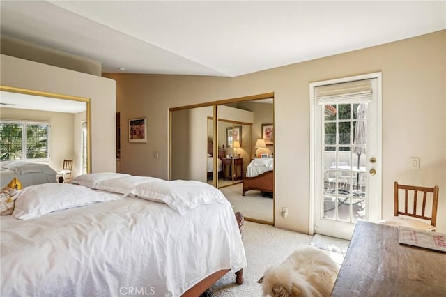 carpeted bedroom with access to exterior, a closet, and vaulted ceiling