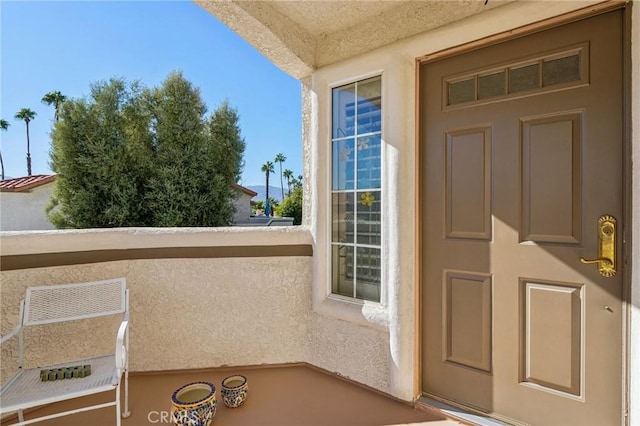 entrance to property featuring a balcony