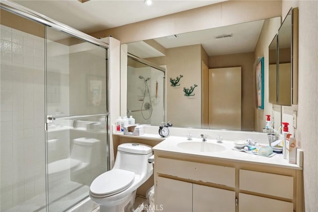 bathroom with vanity, an enclosed shower, and toilet