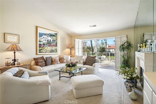 carpeted living room featuring vaulted ceiling