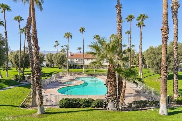 view of swimming pool with a lawn and a patio area