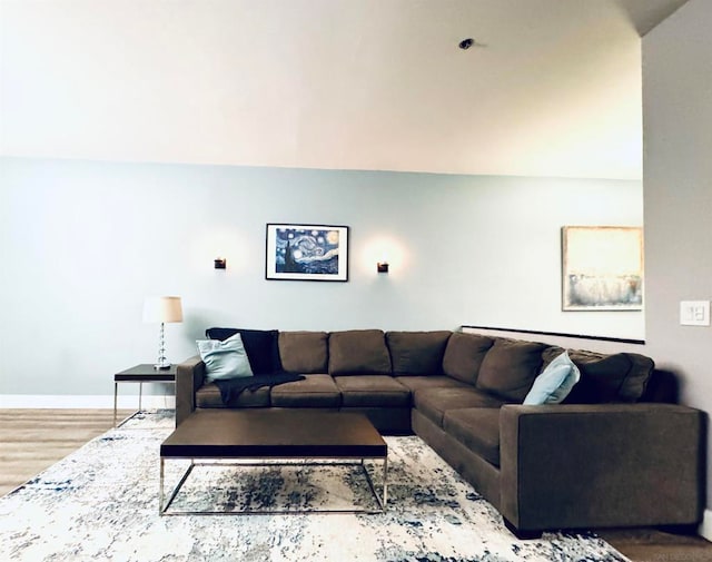 living room with lofted ceiling and hardwood / wood-style flooring