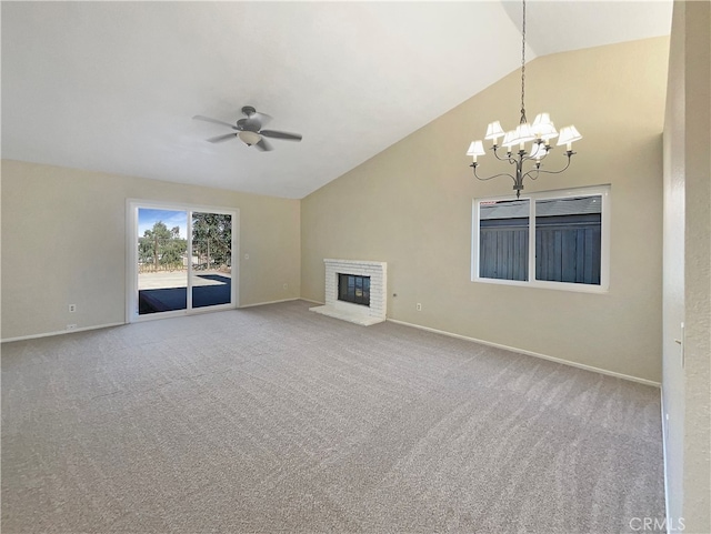 unfurnished living room with a fireplace, carpet floors, and ceiling fan with notable chandelier