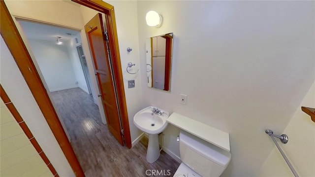 bathroom with toilet and hardwood / wood-style flooring