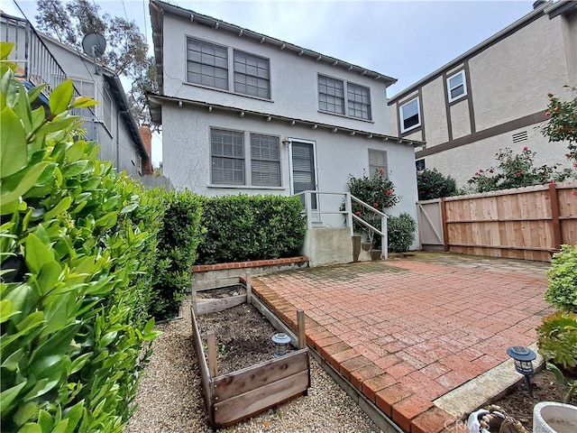 back of house with a patio area