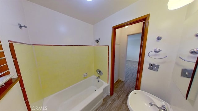 bathroom with wood-type flooring and bathing tub / shower combination