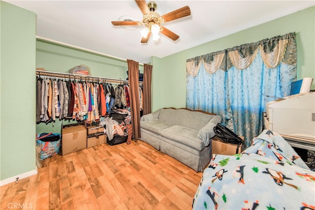 bedroom featuring hardwood / wood-style flooring, a closet, and ceiling fan