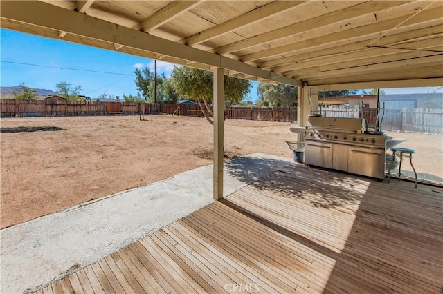 deck featuring a patio, a grill, and a fenced backyard