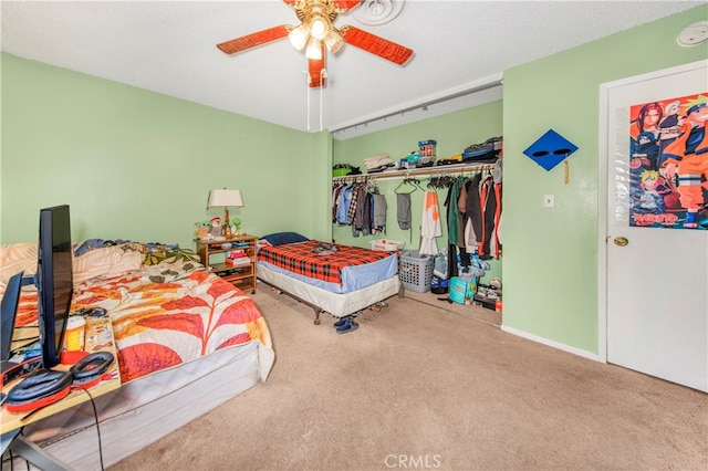 carpeted bedroom with a closet, ceiling fan, and a textured ceiling