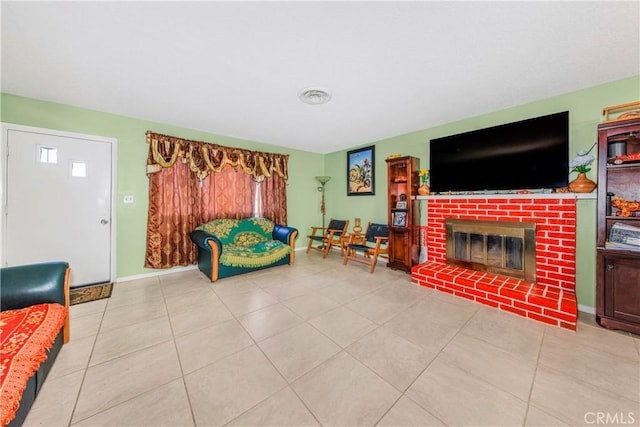 living room featuring tile patterned flooring, a fireplace, visible vents, and baseboards