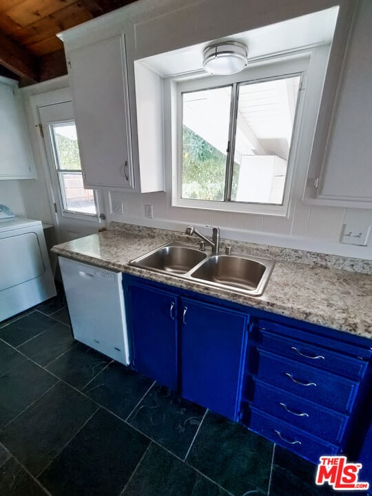 kitchen featuring white cabinets, sink, blue cabinetry, and washer / clothes dryer