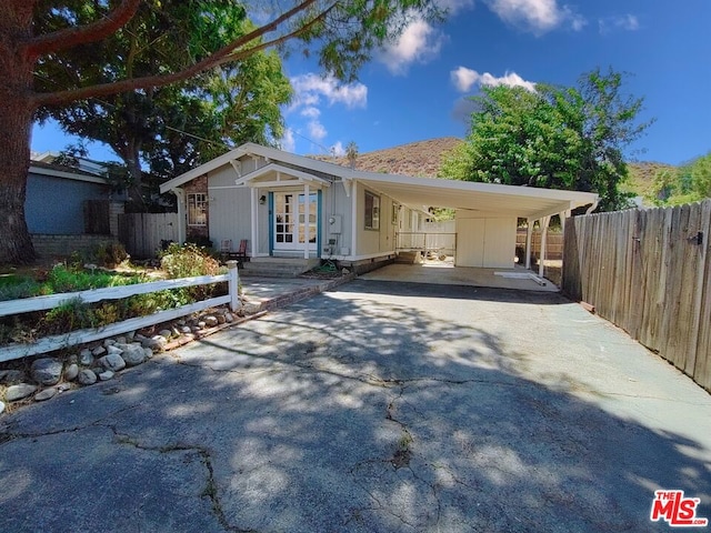 view of front of house featuring a carport and french doors