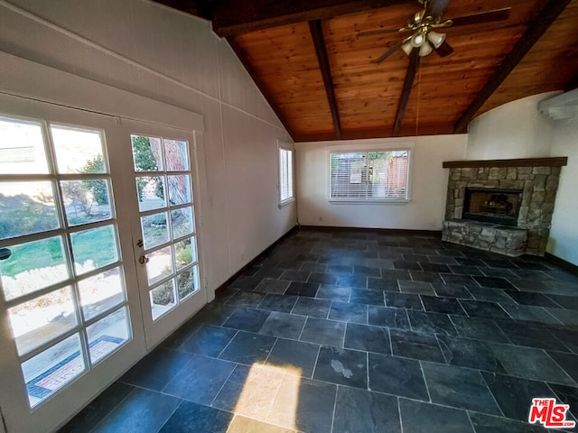 unfurnished living room with a fireplace, lofted ceiling with beams, ceiling fan, and wood ceiling