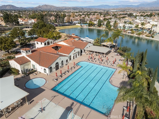 birds eye view of property featuring a water and mountain view