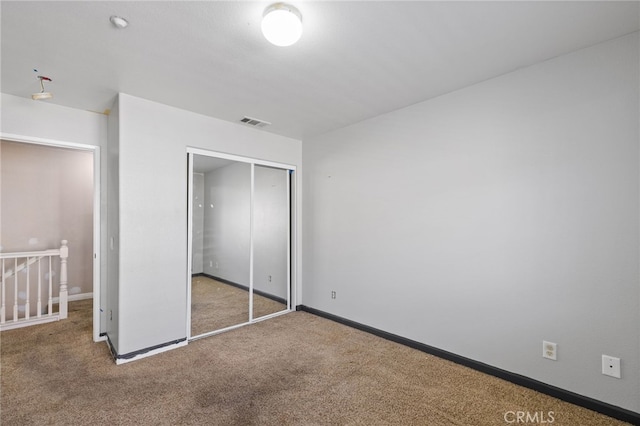 unfurnished bedroom featuring a closet and carpet flooring