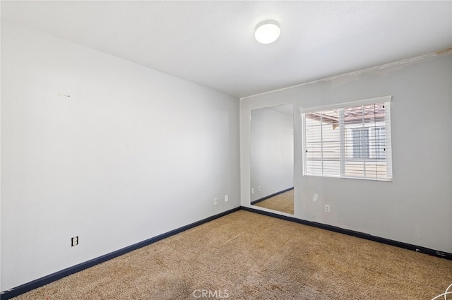 unfurnished room featuring carpet