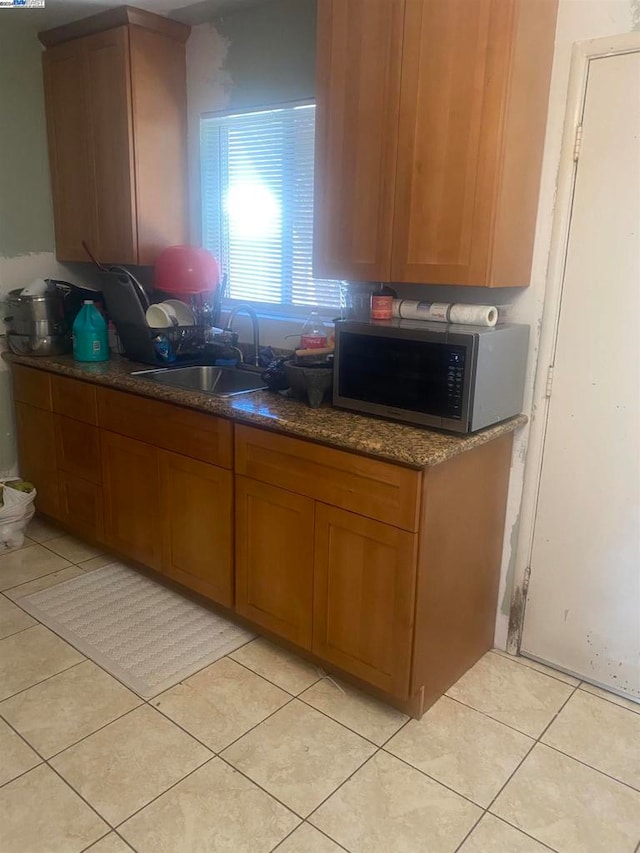 kitchen with sink and light tile patterned flooring