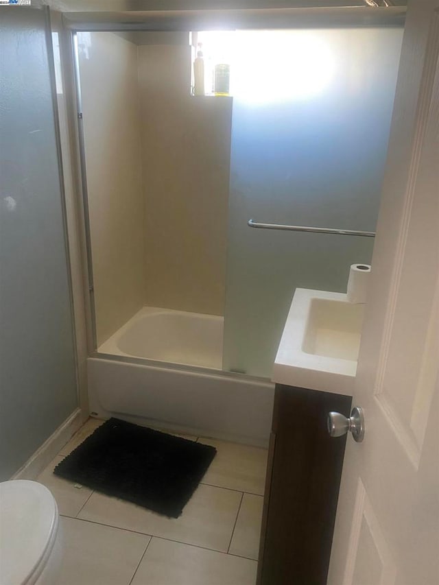 full bathroom featuring vanity, toilet, combined bath / shower with glass door, and tile patterned flooring