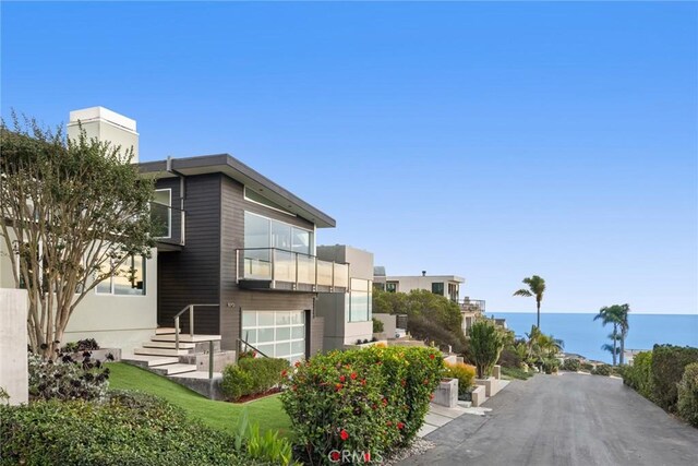 exterior space with a garage and a water view