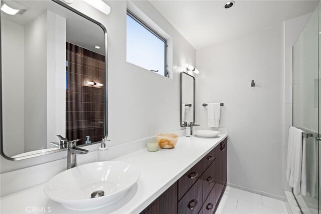 bathroom with tile patterned floors, vanity, and an enclosed shower