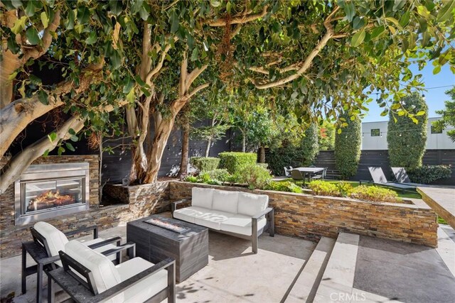 view of patio featuring an outdoor living space with a fireplace