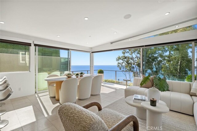 sunroom featuring a water view and plenty of natural light