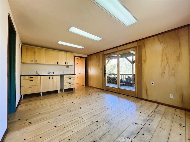 kitchen featuring light brown cabinetry and light wood-type flooring