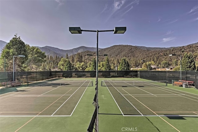 view of tennis court featuring a mountain view