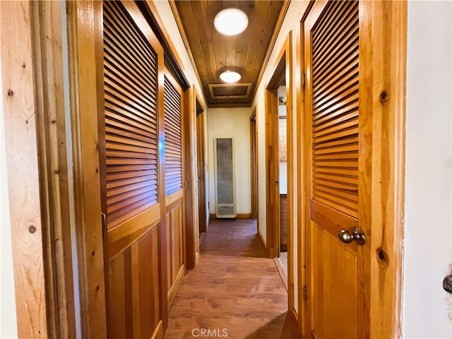 corridor with dark wood-type flooring and wooden ceiling