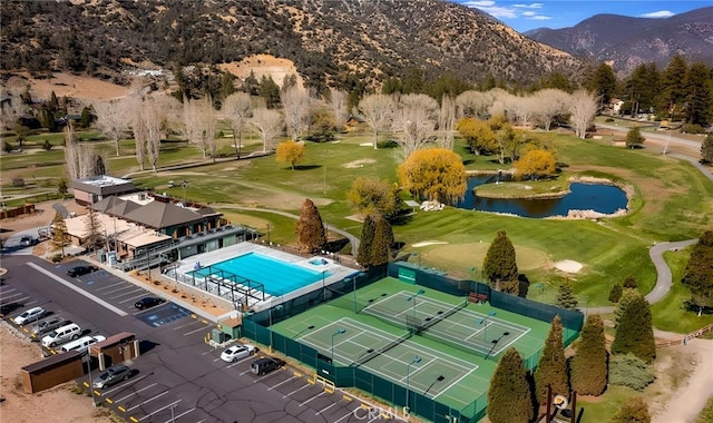 birds eye view of property with a water and mountain view