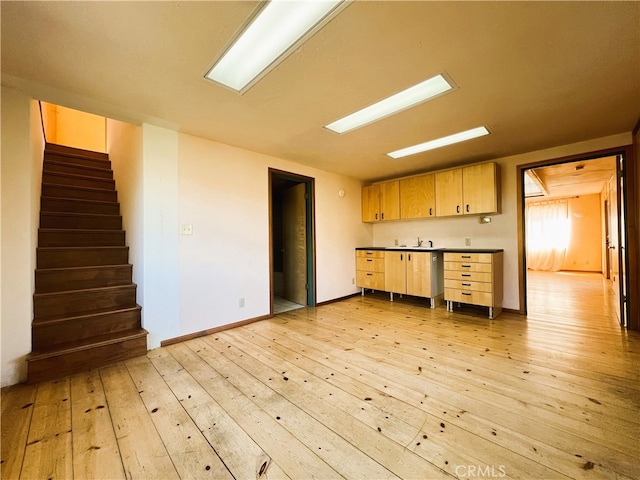 kitchen featuring light hardwood / wood-style floors, light brown cabinetry, and sink