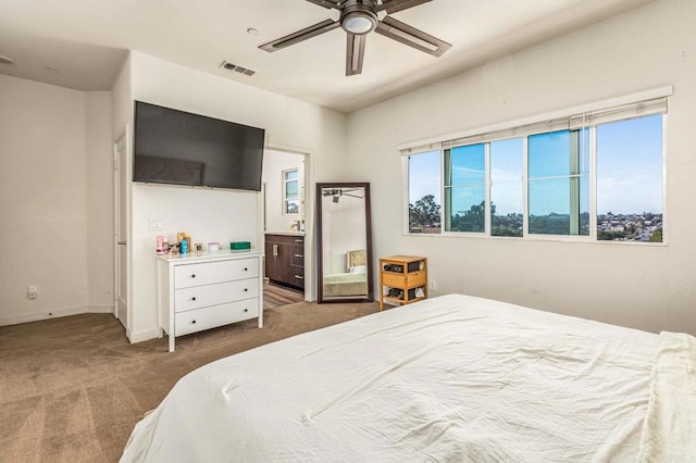 bedroom featuring ensuite bath, carpet floors, and ceiling fan