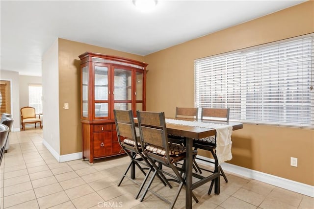 tiled dining room with a wealth of natural light