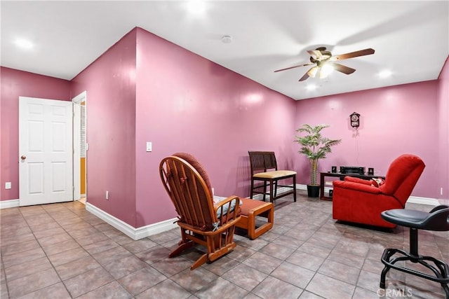 living area featuring ceiling fan and light tile patterned floors